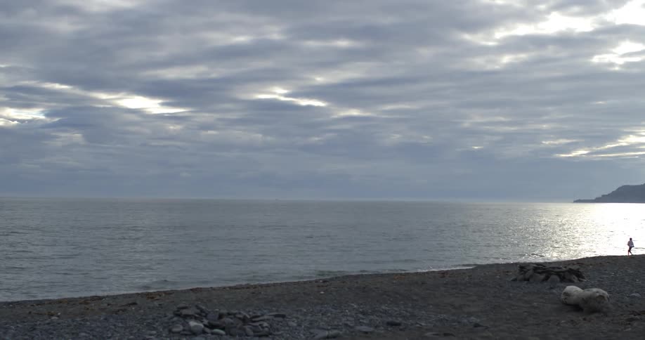 Waves roll in silently along a rocky beach