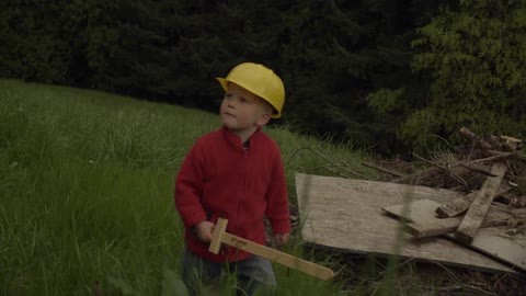A young boy wields at wood sword
