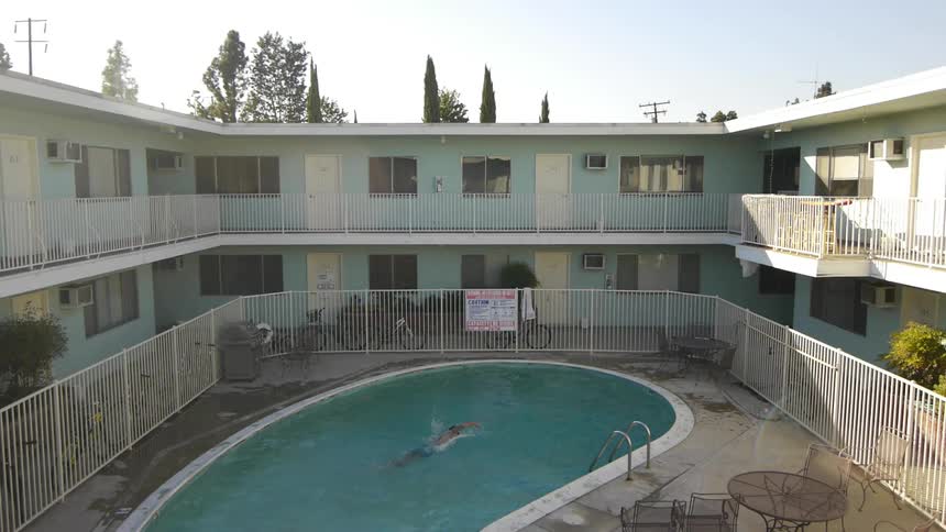A man swims in a motel swimming pool