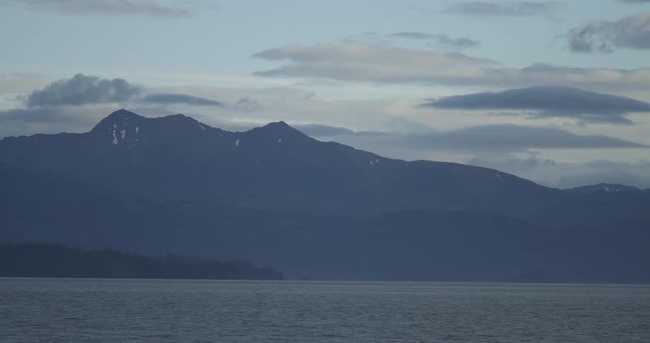 A view across a large body of water with the mountains in the distance