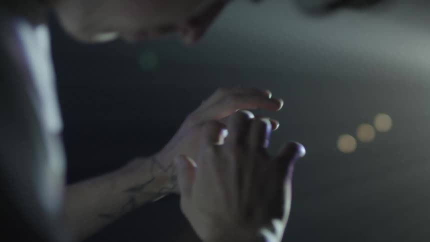 A man is blinded by lights being shown in his eyes