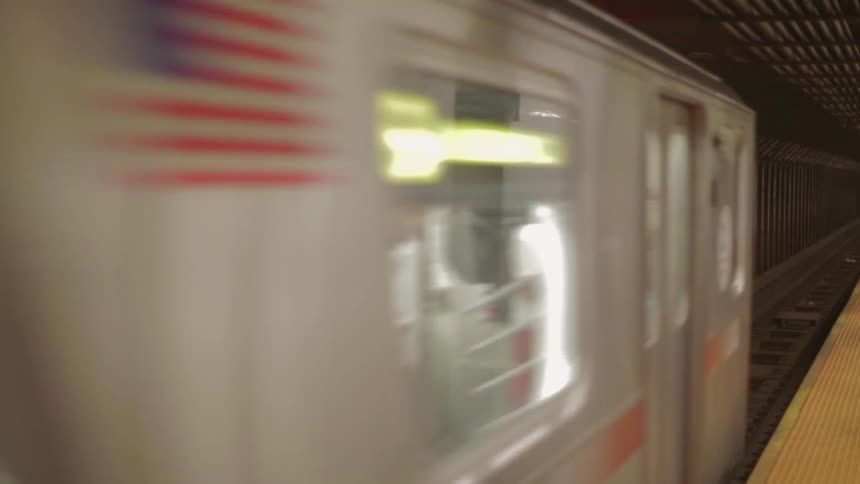 A train rolls into the station at night