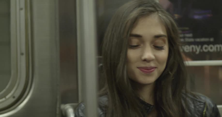 A woman sits and smiles
