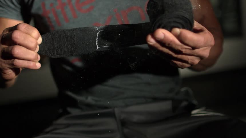A man unwraps a Velcro strap