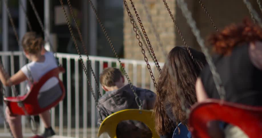 Children riding a carnival swing ride