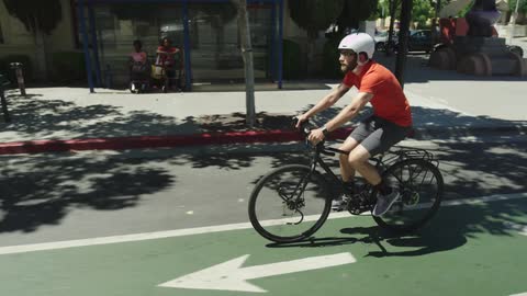 A man riding a ten speed down a city street