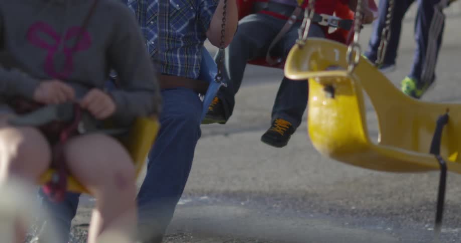 People riding swings at the fair
