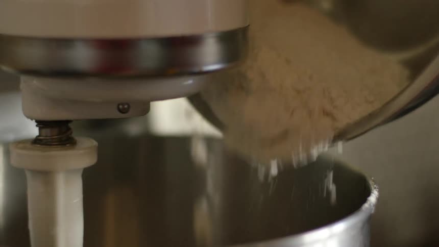 Flour is poured into a stand mixer