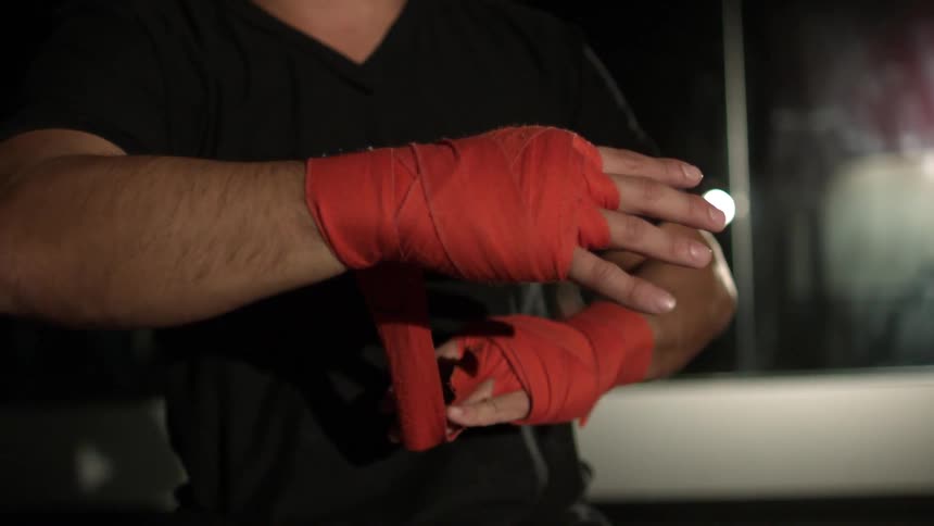 Man wraps hand in red cloth