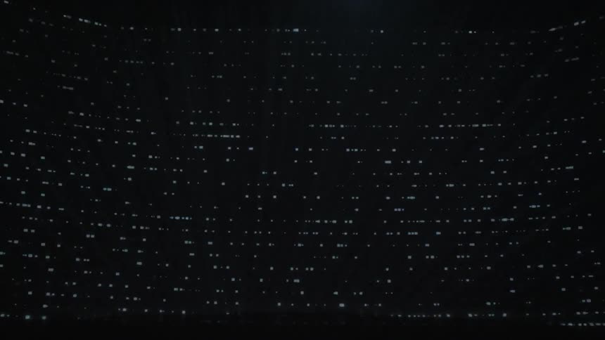 A computer displays information at night