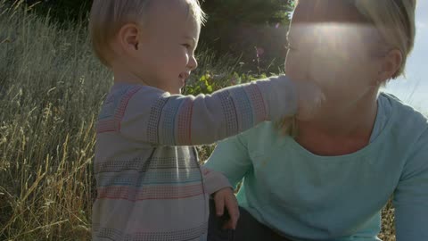 Baby gives mother some grass