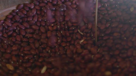 Red beans being poured into a container