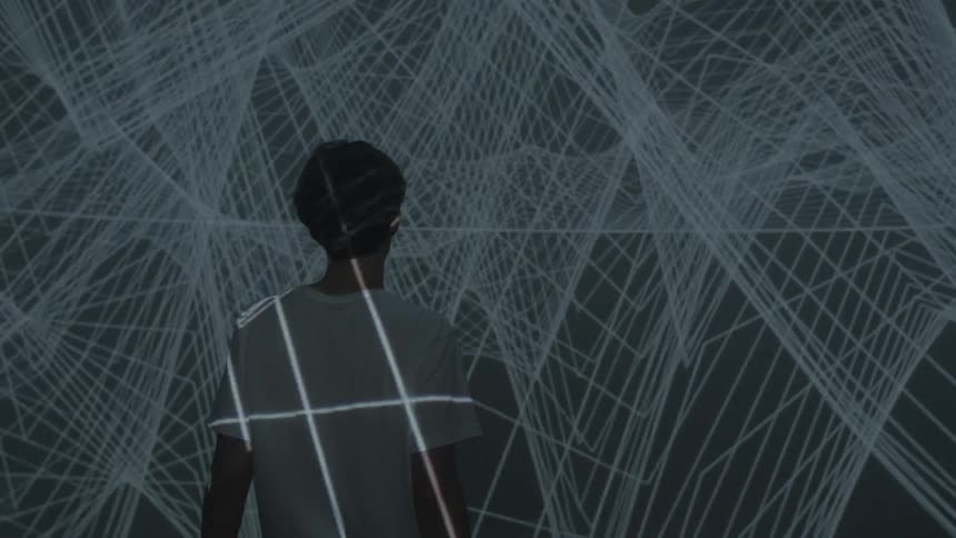 Graphics are projected onto a wall and man's back