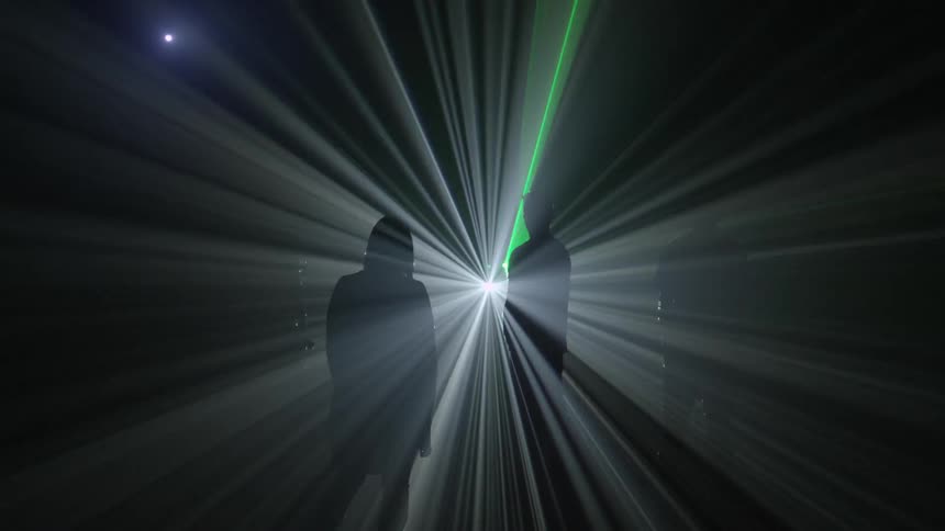 People standing in front of strobe lights