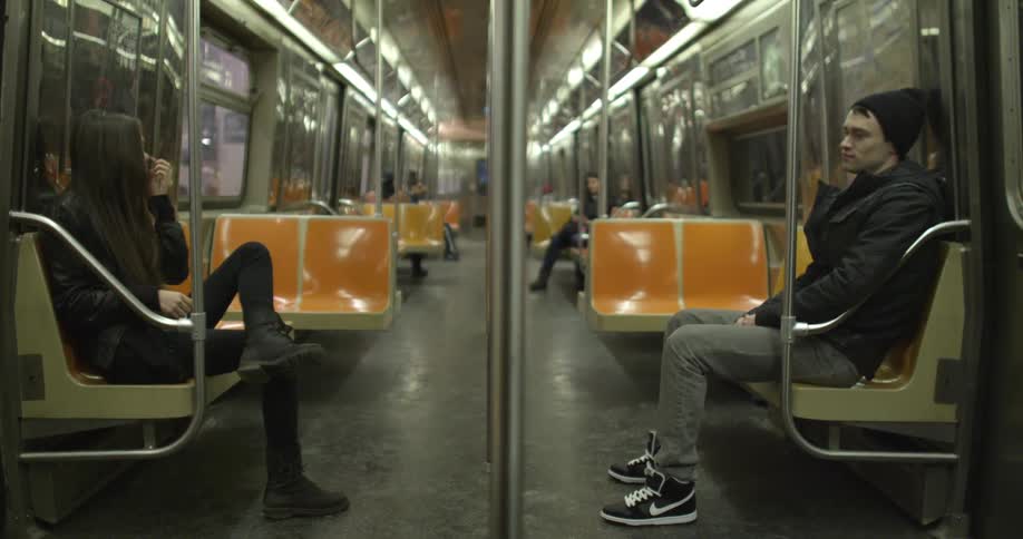 A woman enters an underground subway car
