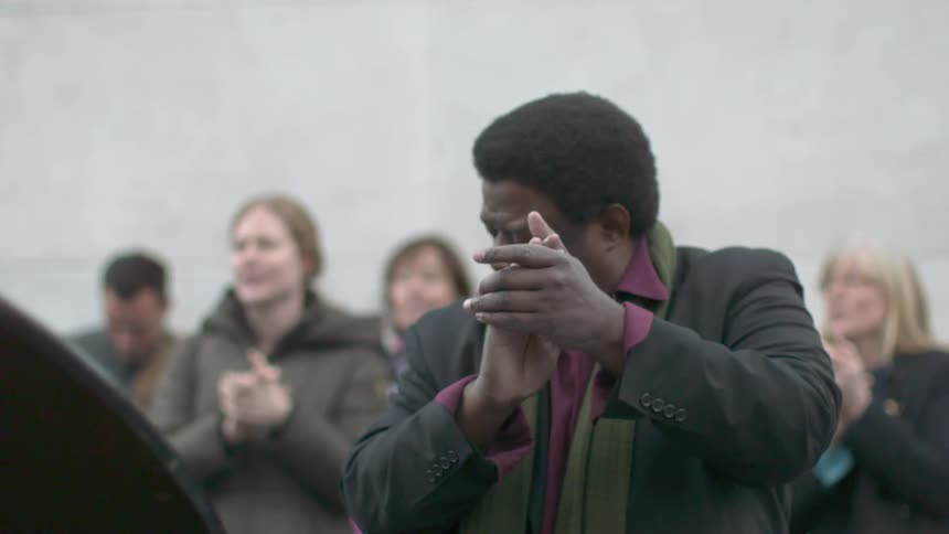 A group of people clap their hands in slow motion