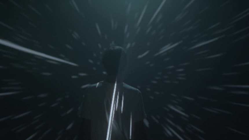 A man standing in front of a screen with lights projecting all around him