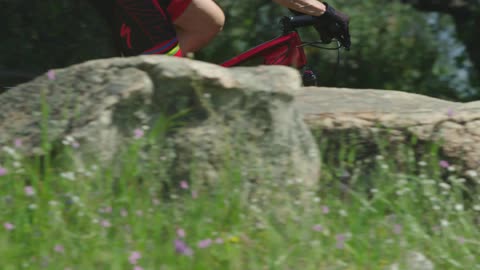 Man biking throw a flowering field